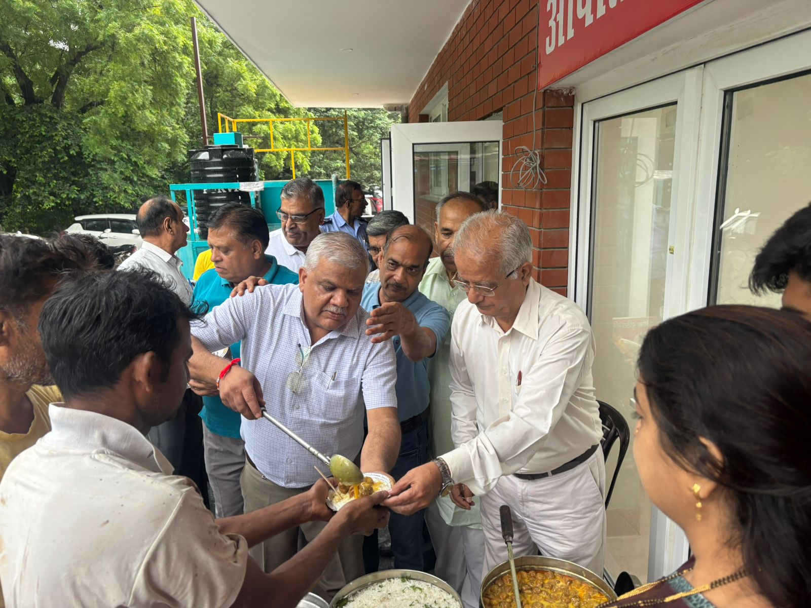 Matri Seva Trust trustees serving meals to families outside the hospital