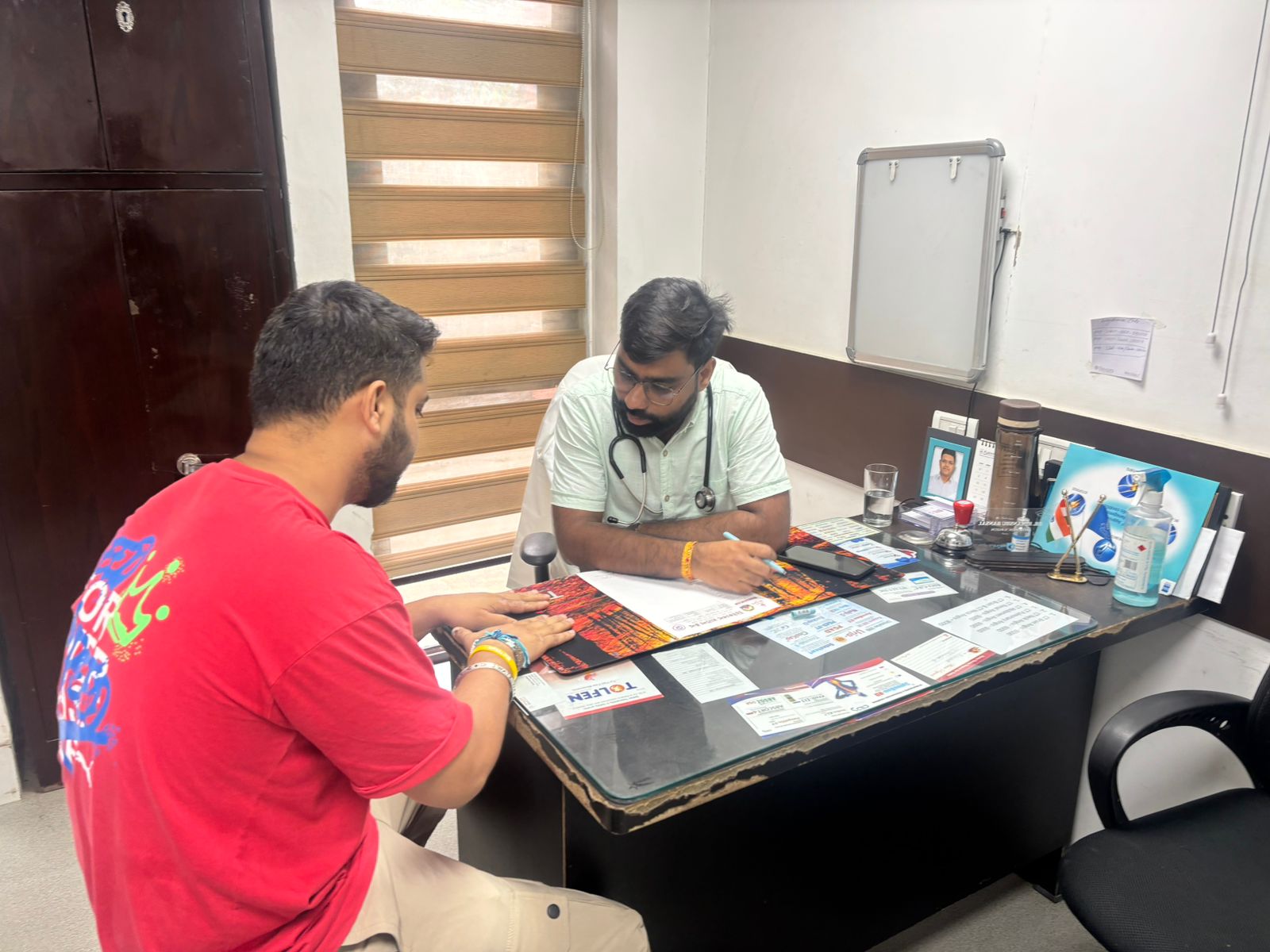 Dr. Prince consulting a patient at Vivekanand Arogya Kendra
