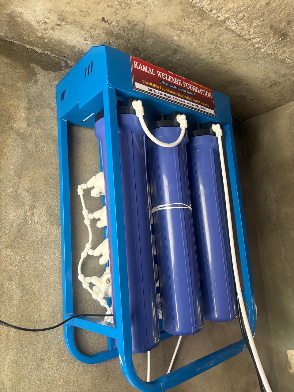 A multi-stage commercial RO filtration unit mounted and plumbed at an installation site