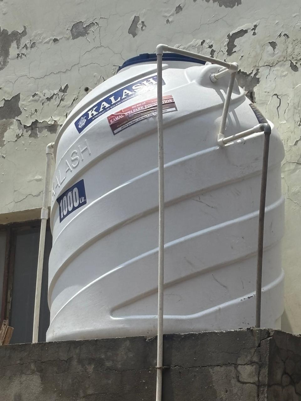 A 1,000-litre food-grade storage tank installed on a raised platform